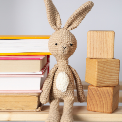 Reading books and blocks with stuffed bunny.